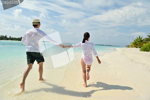 Image of happy young couple have fun on beach