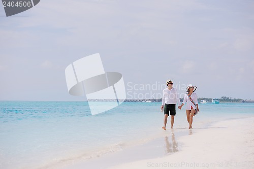 Image of happy young couple have fun on beach