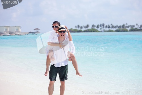 Image of happy young couple have fun on beach