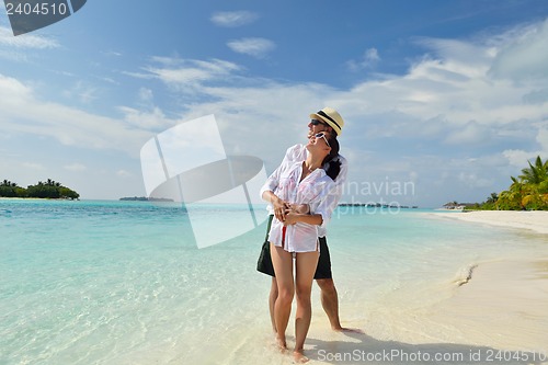 Image of happy young couple have fun on beach