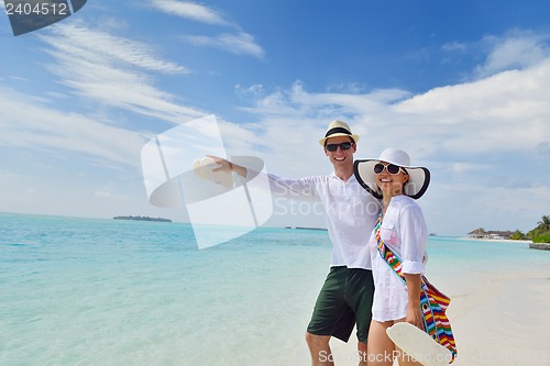 Image of happy young couple have fun on beach