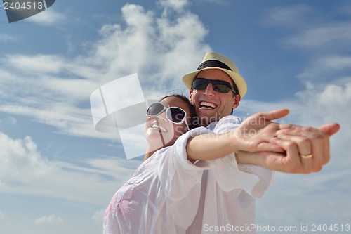 Image of happy young couple have fun on beach