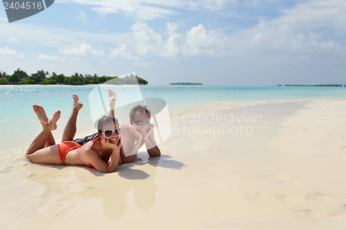 Image of happy young couple have fun on beach