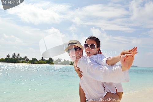 Image of happy young couple have fun on beach