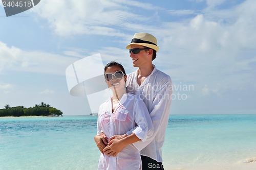 Image of happy young couple have fun on beach