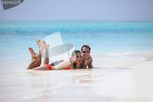 Image of happy young couple have fun on beach