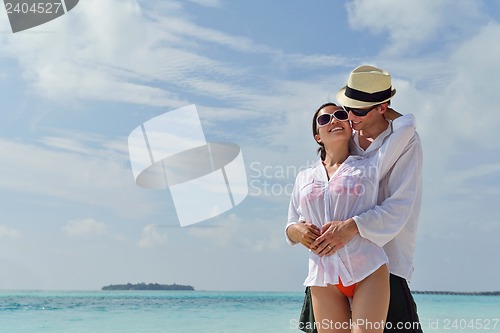 Image of happy young couple have fun on beach