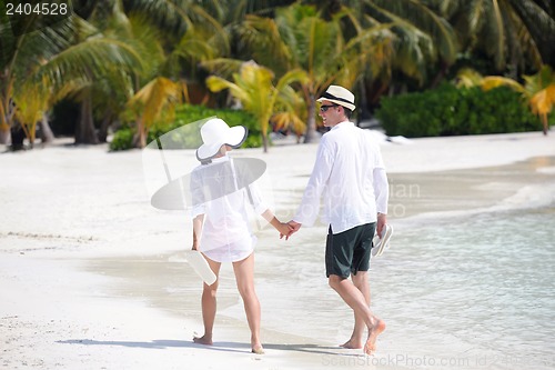 Image of happy young couple have fun on beach