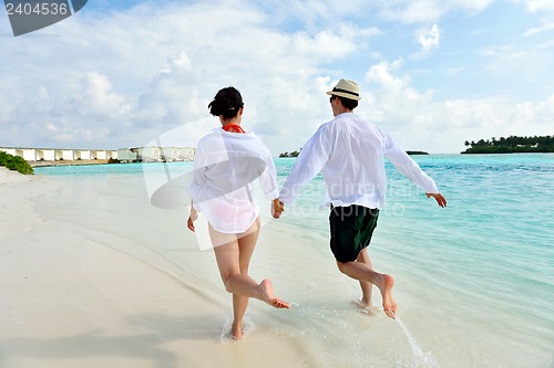 Image of happy young couple have fun on beach