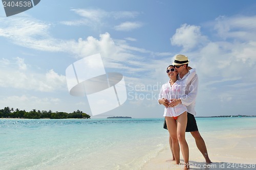 Image of happy young couple have fun on beach