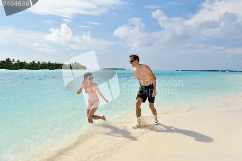 Image of happy young couple have fun on beach