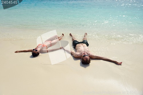 Image of happy young couple have fun on beach
