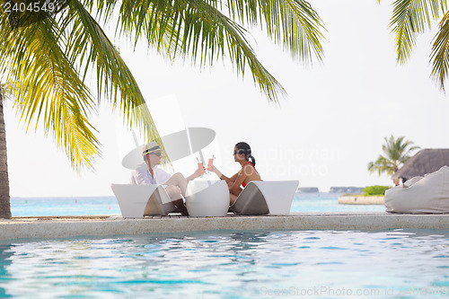 Image of happy young couple relax and take fresh drink