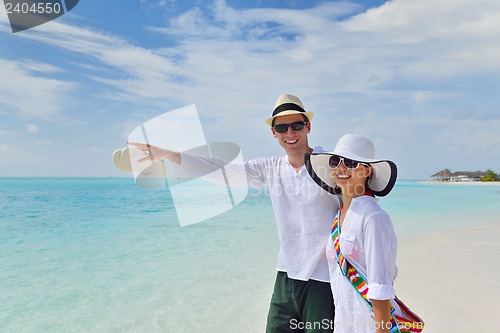 Image of happy young couple have fun on beach