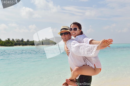 Image of happy young couple have fun on beach