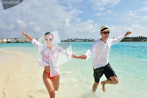 Image of happy young couple have fun on beach