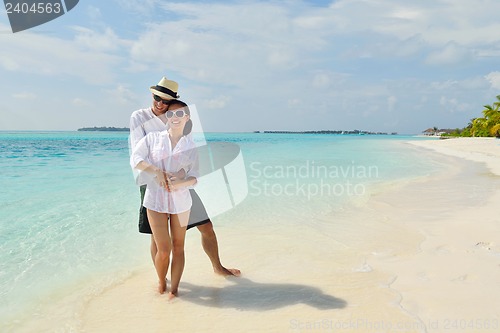 Image of happy young couple have fun on beach