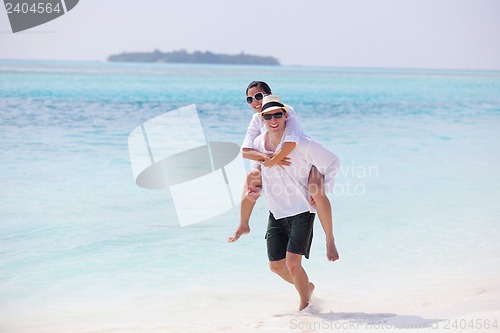 Image of happy young couple have fun on beach