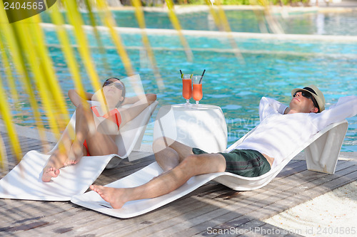 Image of happy young couple relax and take fresh drink