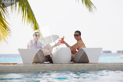 Image of happy young couple relax and take fresh drink