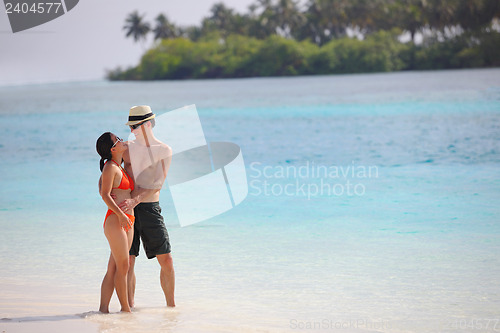 Image of happy young couple have fun on beach