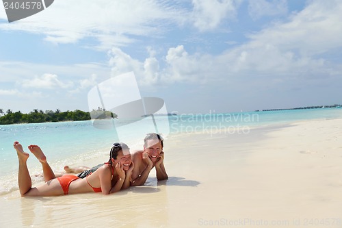 Image of happy young couple have fun on beach