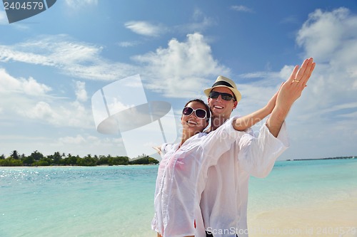 Image of happy young couple have fun on beach