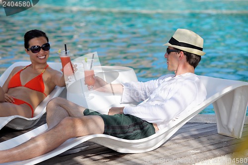 Image of happy young couple relax and take fresh drink