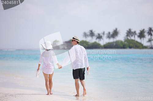 Image of happy young couple have fun on beach