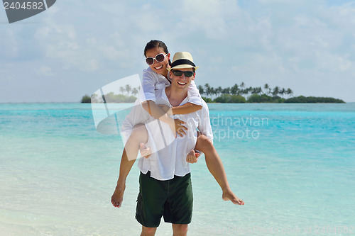 Image of happy young couple have fun on beach