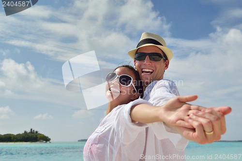 Image of happy young couple have fun on beach