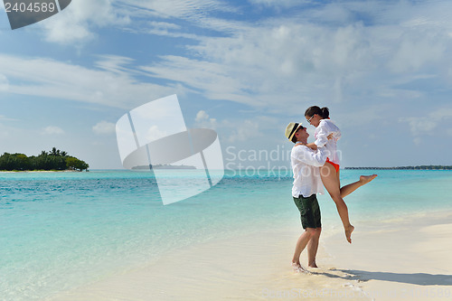 Image of happy young couple have fun on beach