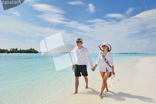 Image of happy young couple have fun on beach