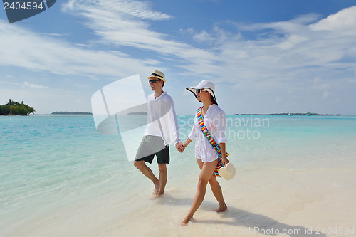 Image of happy young couple have fun on beach