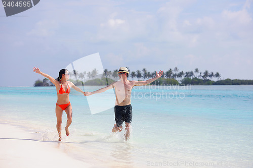 Image of happy young couple have fun on beach