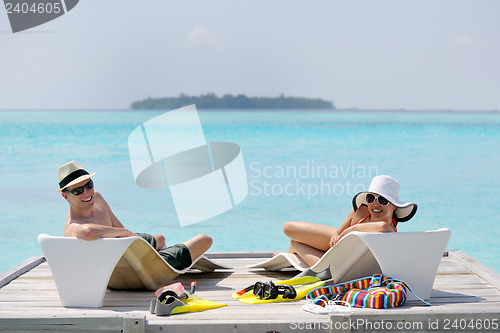 Image of happy young couple have fun on beach