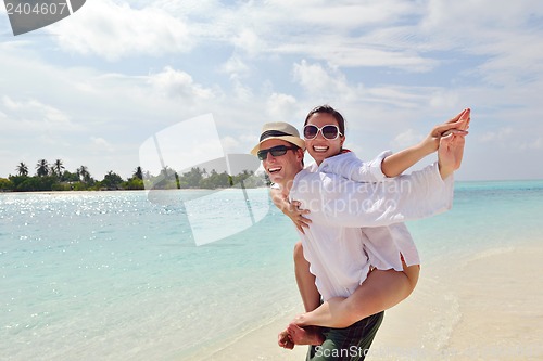 Image of happy young couple have fun on beach