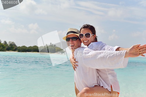 Image of happy young couple have fun on beach