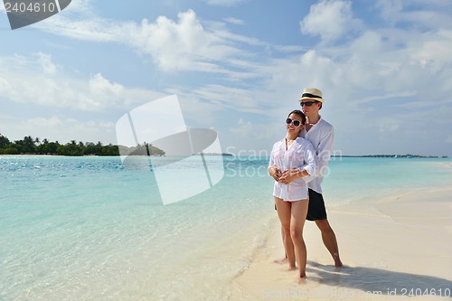 Image of happy young couple have fun on beach