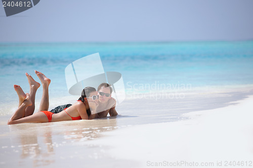 Image of happy young couple have fun on beach