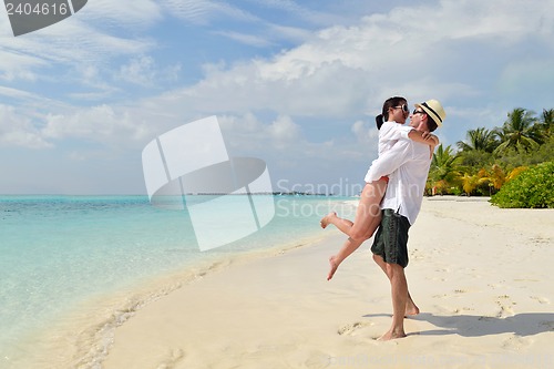 Image of happy young couple have fun on beach