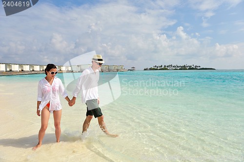 Image of happy young couple have fun on beach
