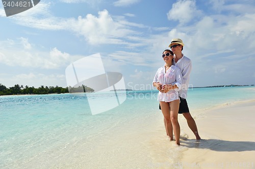 Image of happy young couple have fun on beach
