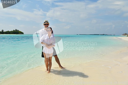 Image of happy young couple have fun on beach