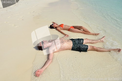 Image of happy young couple have fun on beach