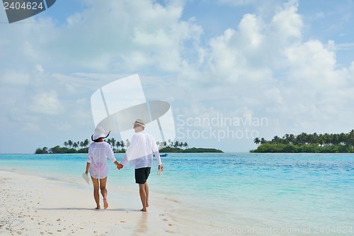 Image of happy young couple have fun on beach