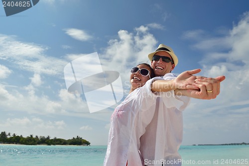 Image of happy young couple have fun on beach