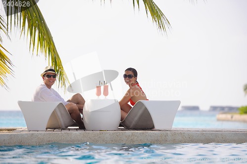 Image of happy young couple relax and take fresh drink