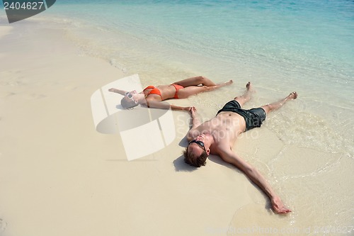 Image of happy young couple have fun on beach