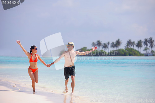 Image of happy young couple have fun on beach